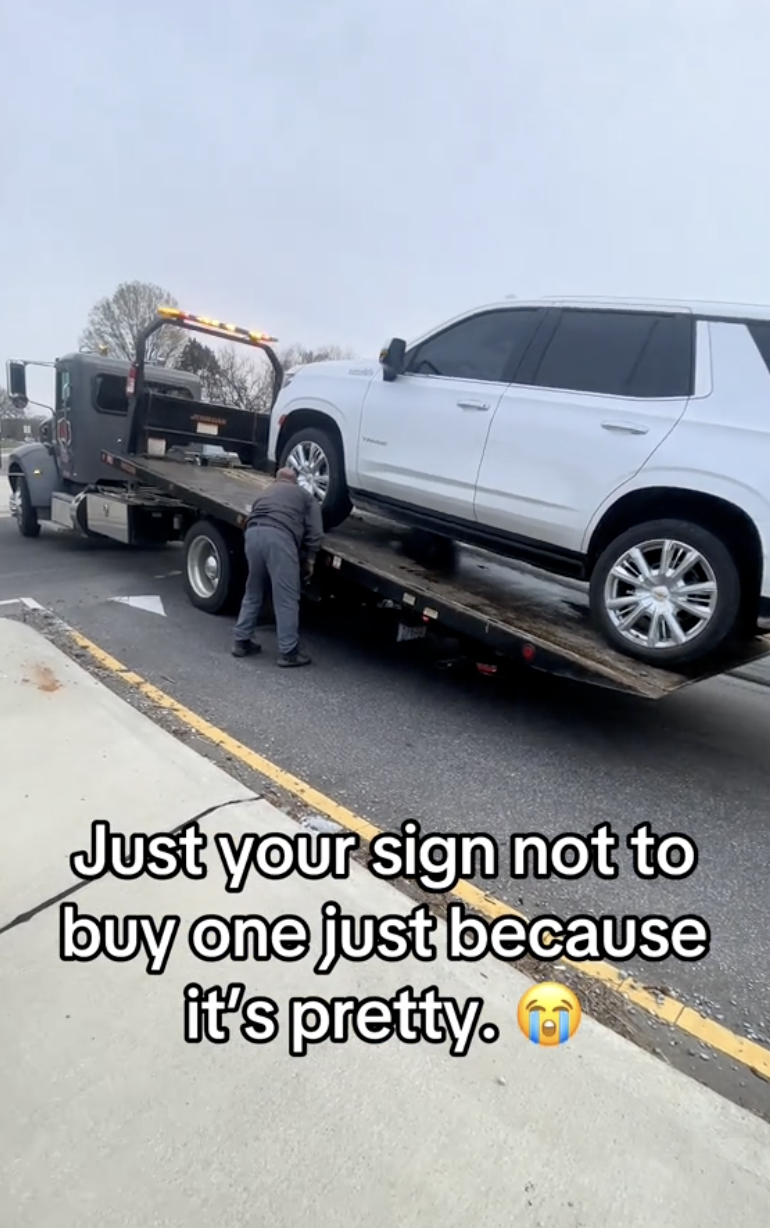 car being loaded onto a tow truck